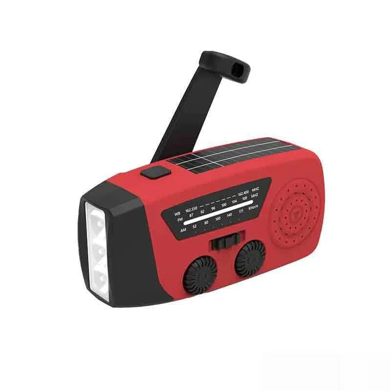 Red rechargeable emergency hand radio with built-in torch, showing compact size and wrist strap.