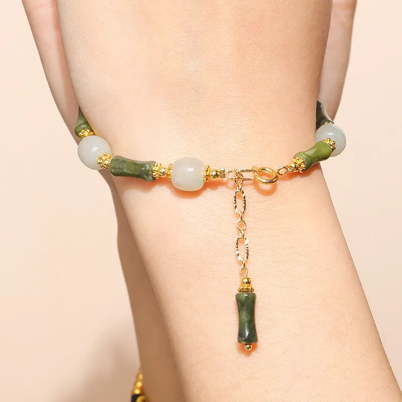Crystal agate charm bracelet with Chinese-style fruit, bow, and animal designs in natural crystal colours