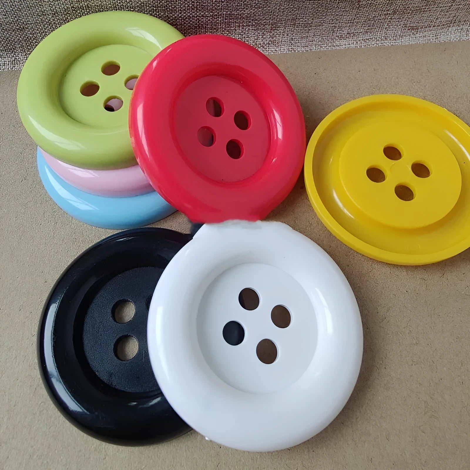 Oversized round edge plastic nylon sewing buttons with four holes in multiple colours