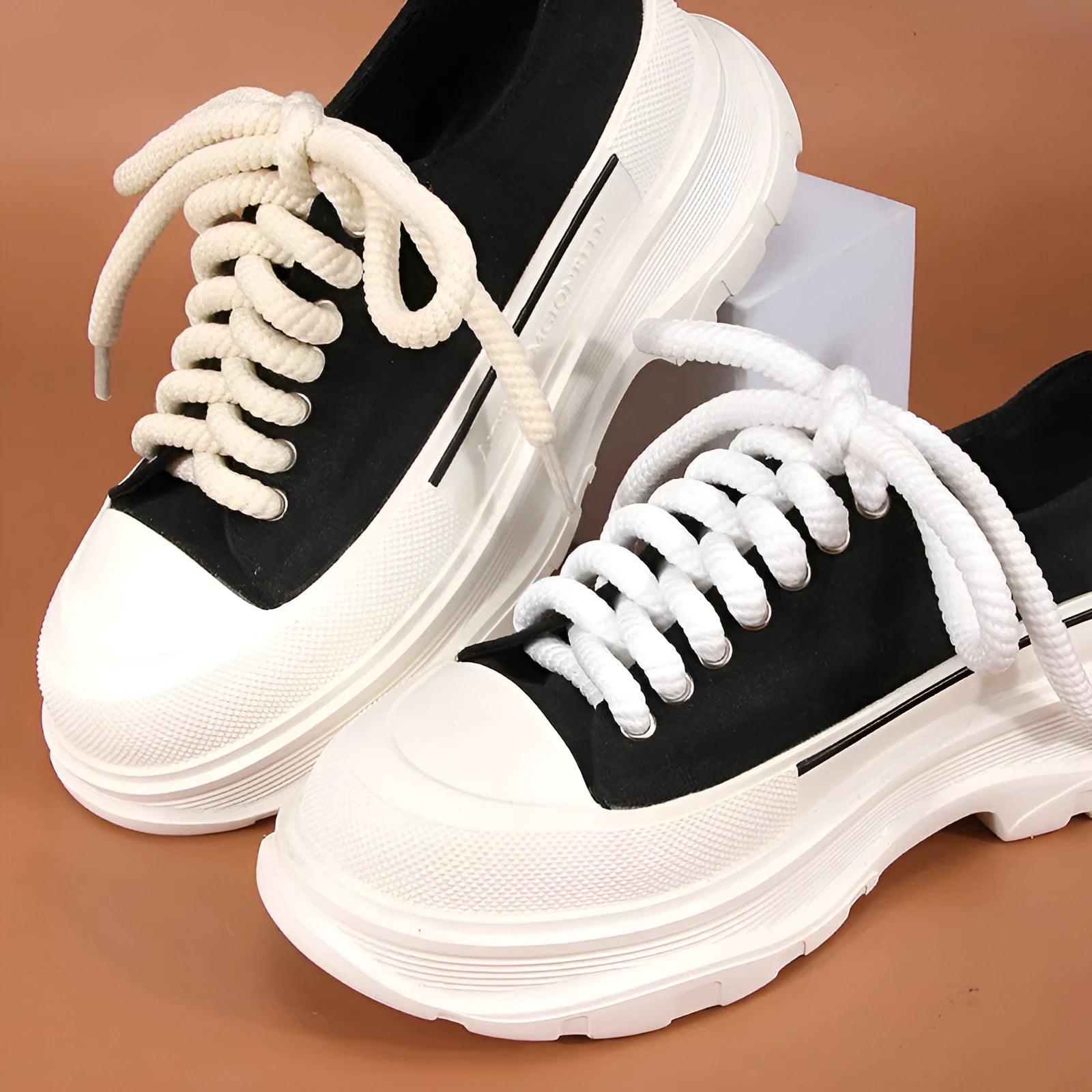 Solid colour round woven shoelaces showing white, black, and beige options with length and thickness choices