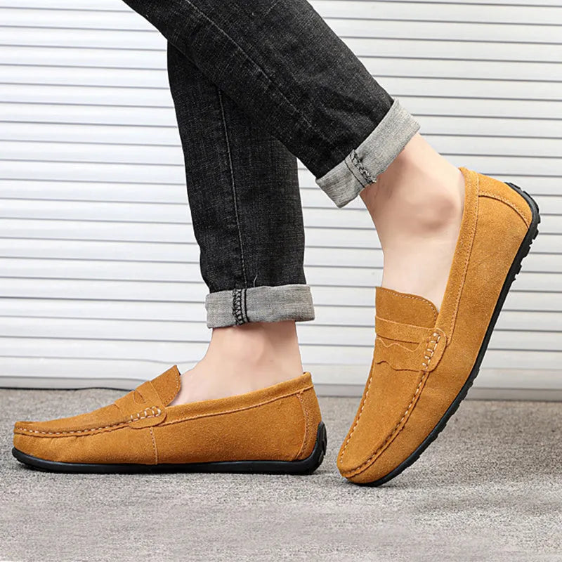 Men's solid colour suede slip-on loafers with a round toe and flat rubber sole.