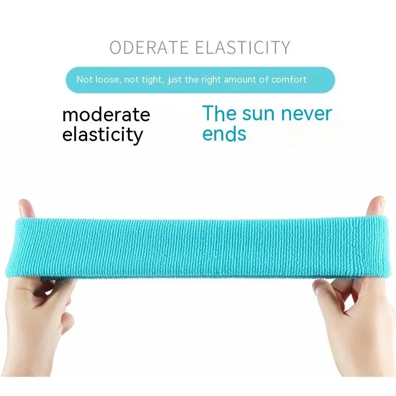 Elastic solid colour sports sweatband in black, shown flat.