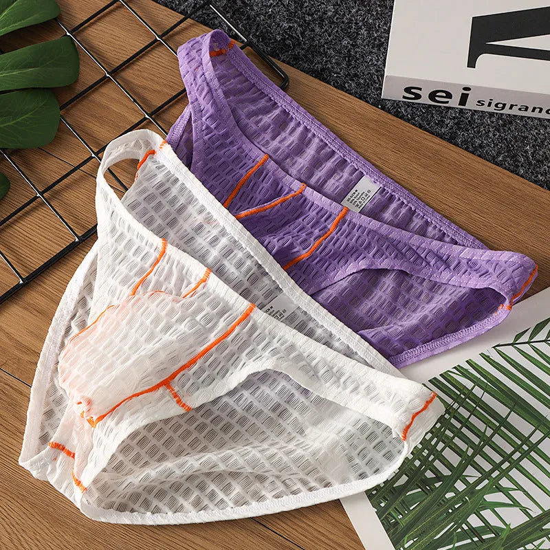 Men's low waist lace briefs in ice silk fabric on solid colour background