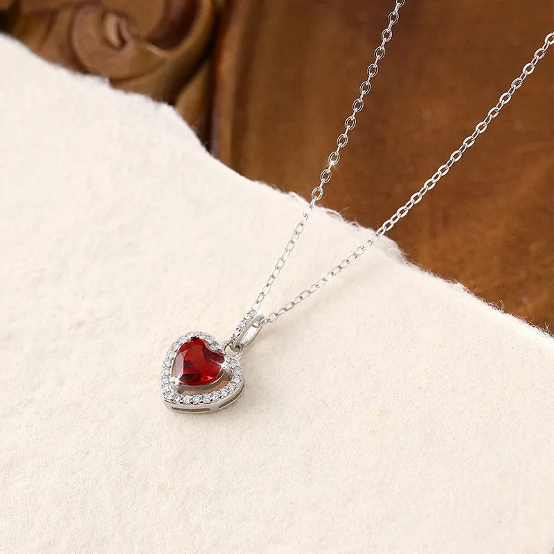 Sterling silver necklace with heart-shaped natural gemstone pendant on adjustable cross chain
