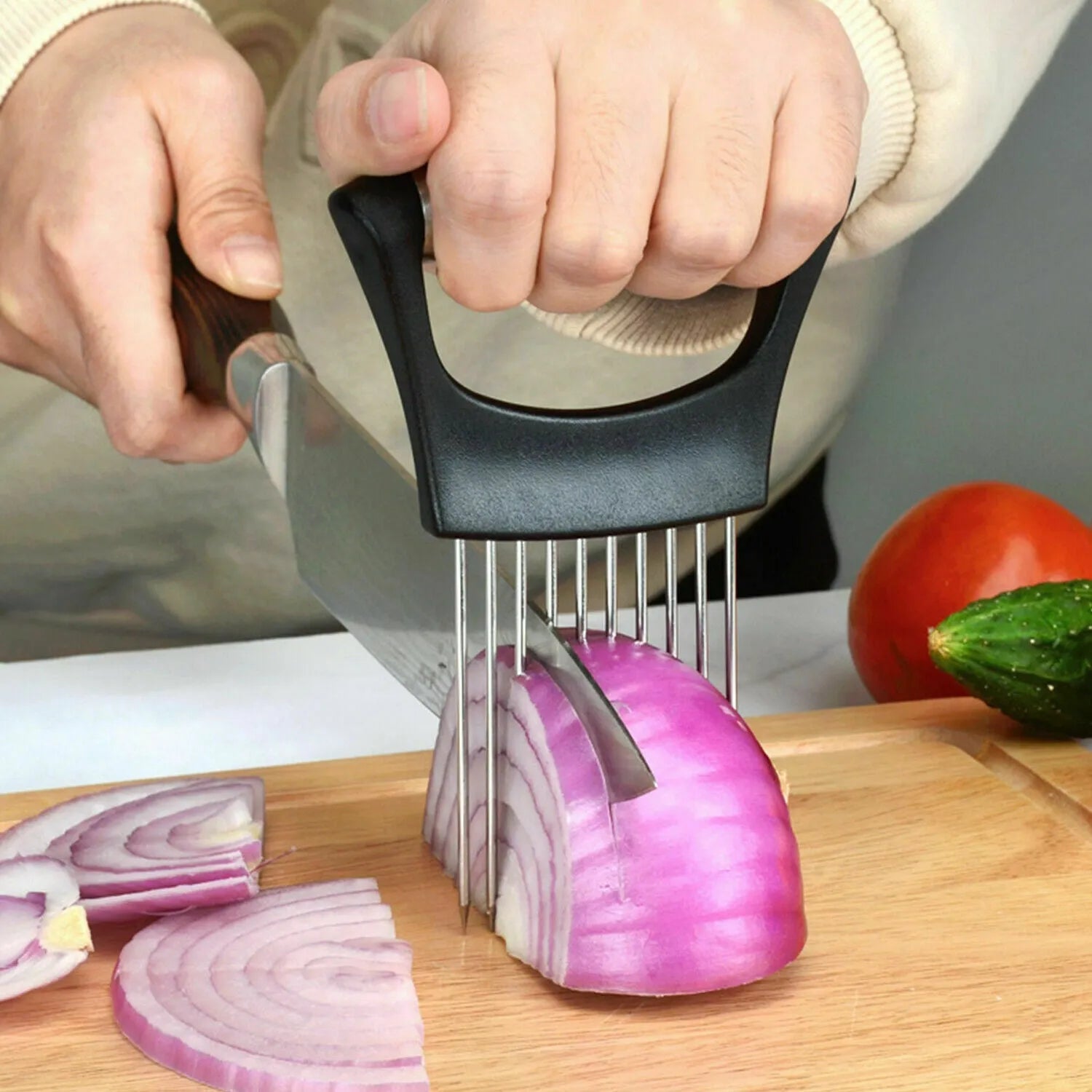 Stainless steel onion and tomato slicer holder with ABS handle on a kitchen worktop
