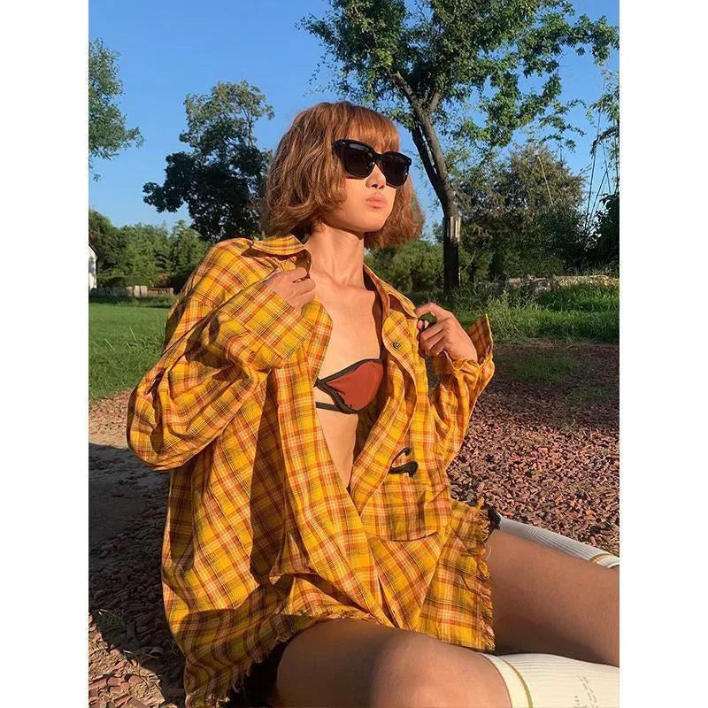 Dopamine yellow plaid shirt with loose cardigan fit on a hanger.
