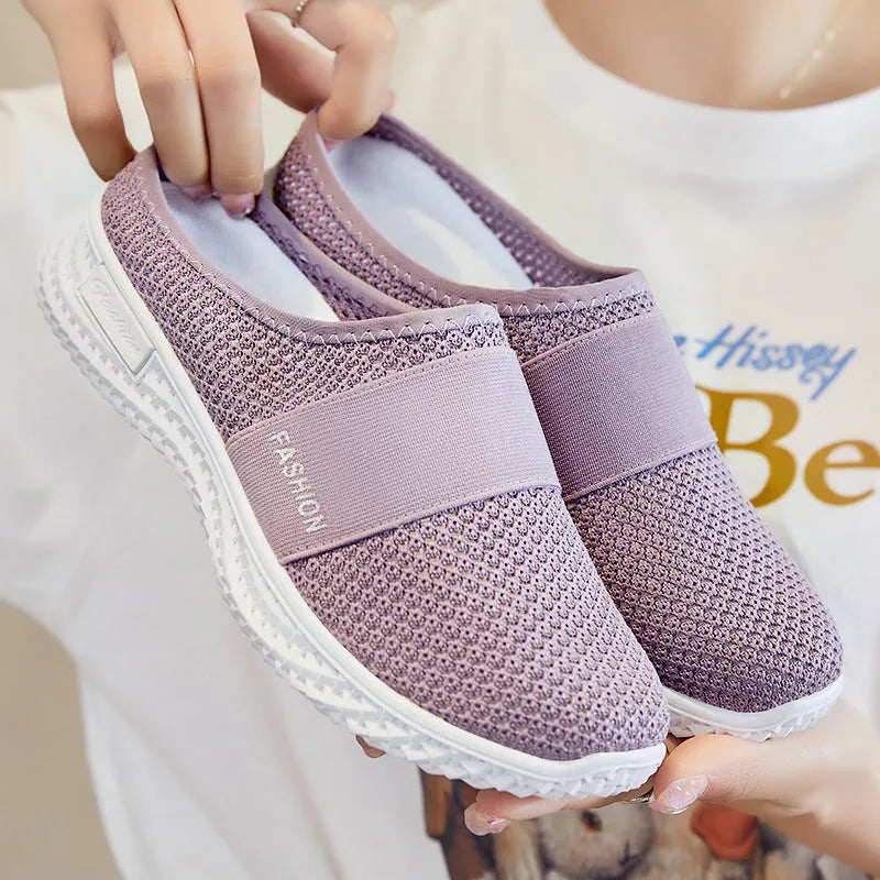 Women's breathable casual shoes with hollow-out mesh upper and flat heel in black, grey, pink, or purple