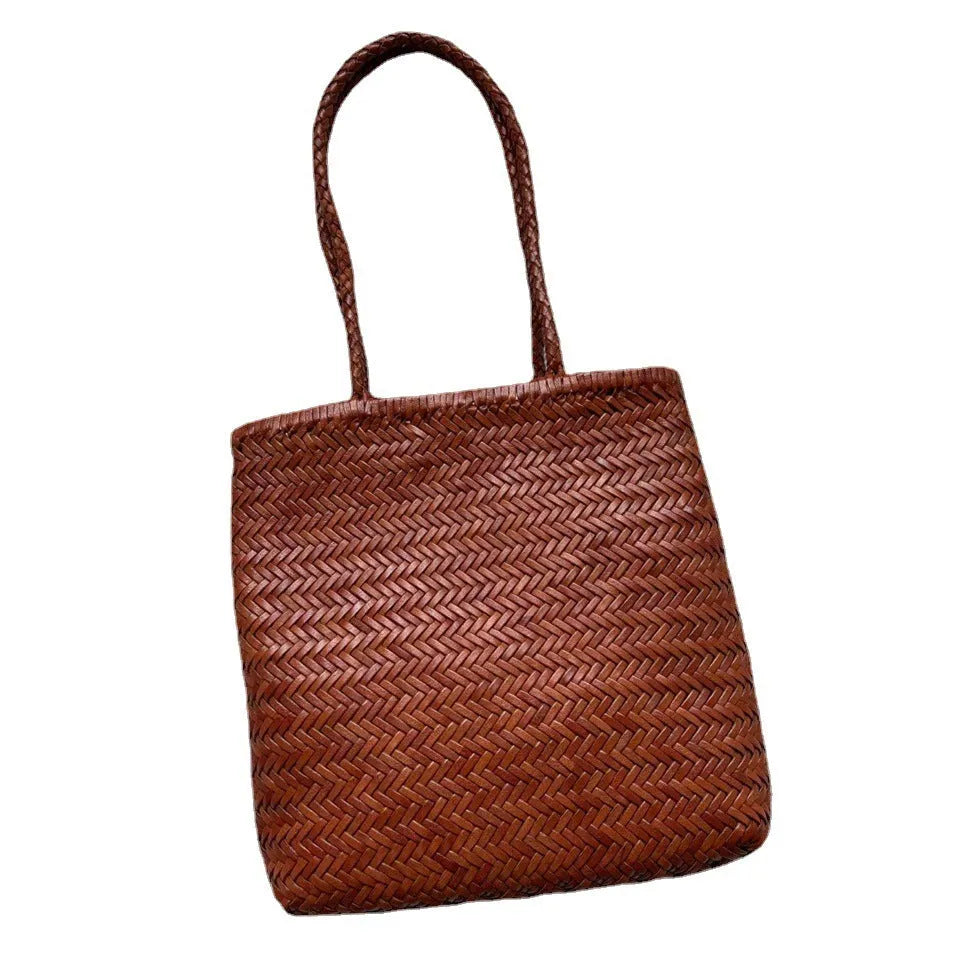 Brown handmade woven tote bag with three-dimensional pocket design and cowhide leather construction