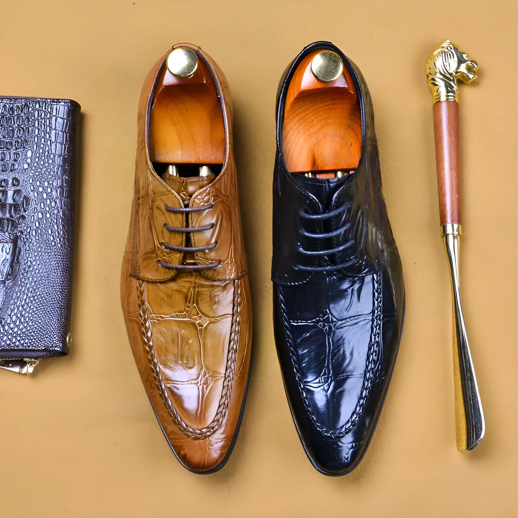 Men's brown leather shoes with alligator pattern texture and a silver horse bit buckle on the front.