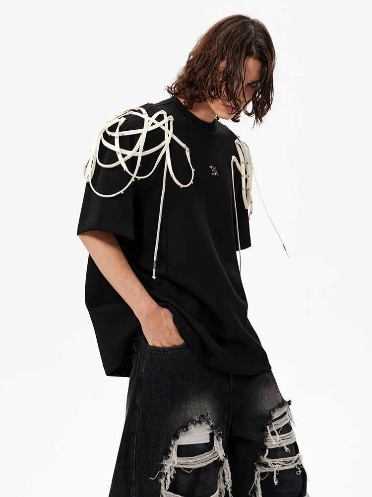 Black loose fit short-sleeved t-shirt with padded shoulder detail and rivet ribbon accents