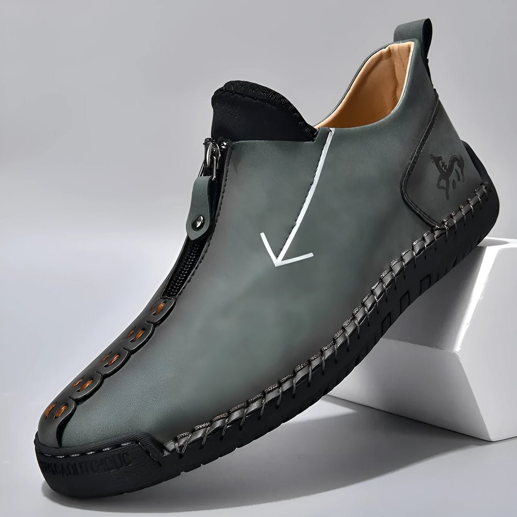 Men's black zip-up casual leather boots with round toe and hand-stitched rubber sole.