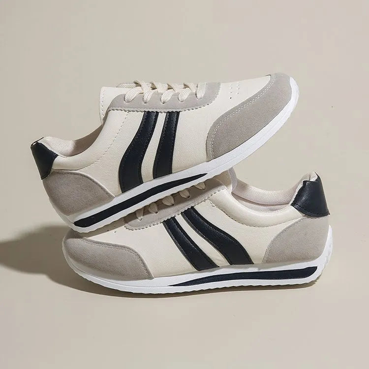 A pair of low-top red and blue lace-up running sneakers with a PU mesh upper and rubber sole on a white background.