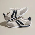 A pair of low-top red and blue lace-up running sneakers with a PU mesh upper and rubber sole on a white background.