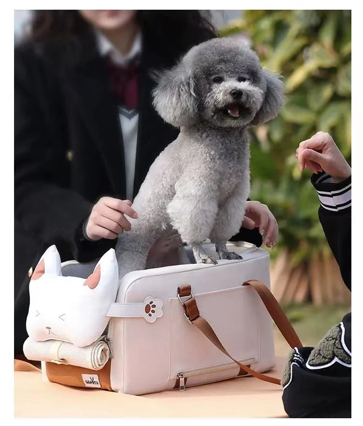Beige hard-sided pet travel crate with a one-shoulder carry strap, shown with dimensions 43cm by 25cm by 22.5cm.