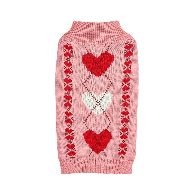 Red dog sweater with a white love heart and bow decoration on a small dog.