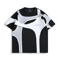Man wearing a black loose fit short sleeve t-shirt with double stitching and padded shoulders.