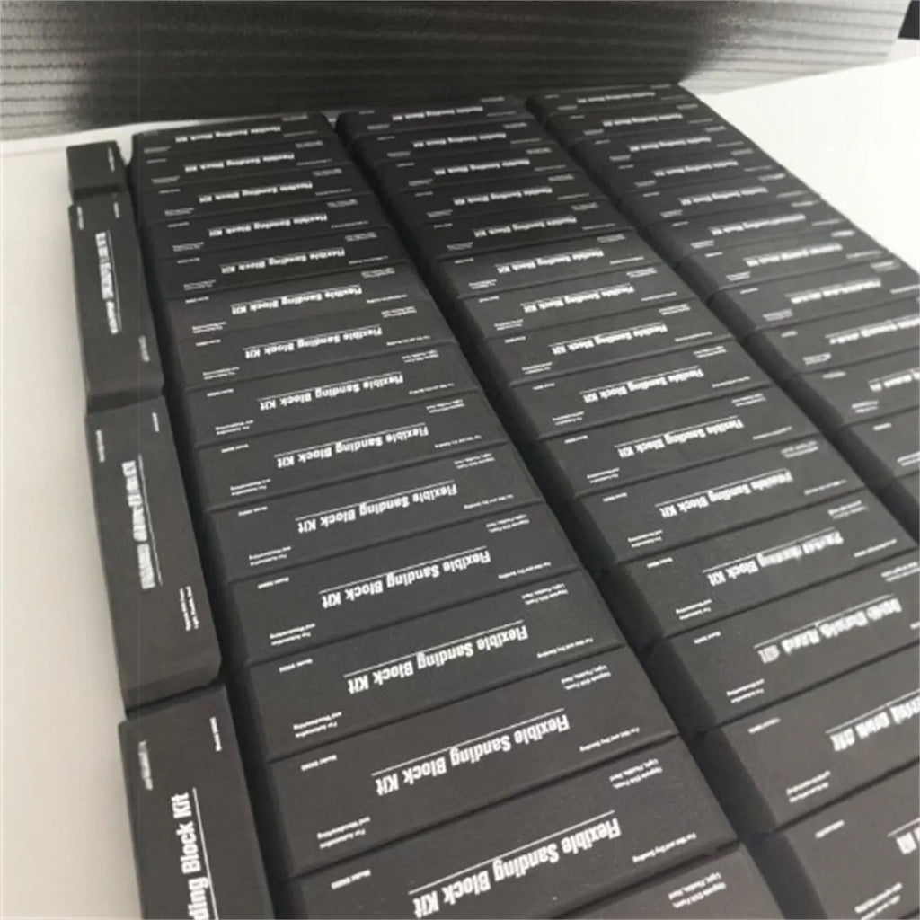 Set of seven black frosted EVA blocks with metal caps arranged together