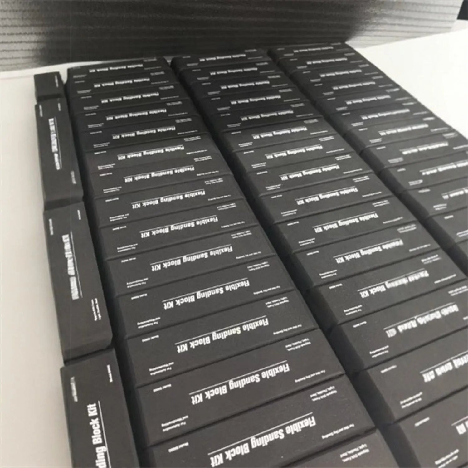 Set of seven black frosted EVA blocks with metal caps arranged together