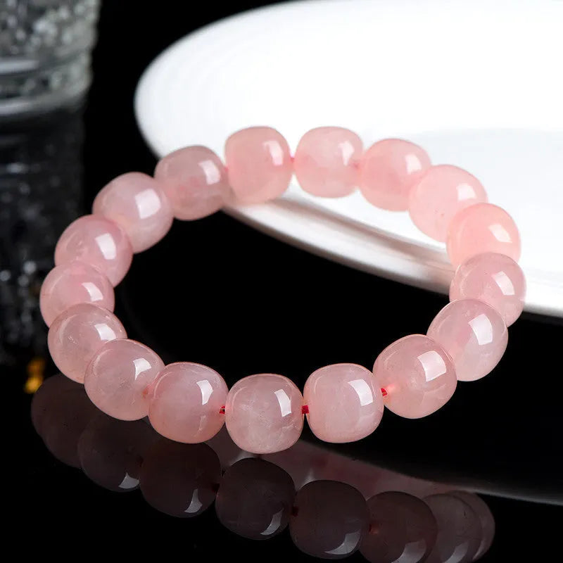 Pink crystal barrel bead bracelet with geometric 8x10mm beads on wrist
