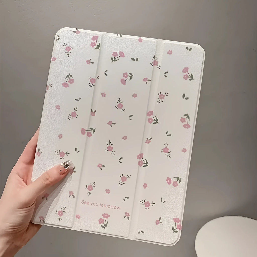 Transparent floral tri-fold iPad protective case with built-in stand, shown closed with magnetic clasp.