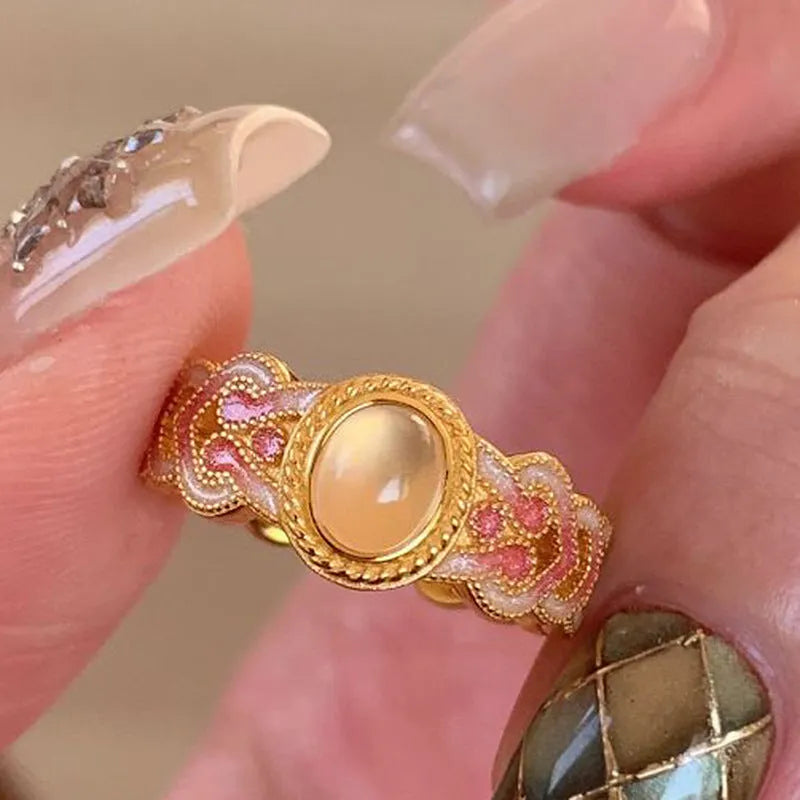 Open geometric ring with pink crystal enamel decoration and gold-plated finish, adjustable design