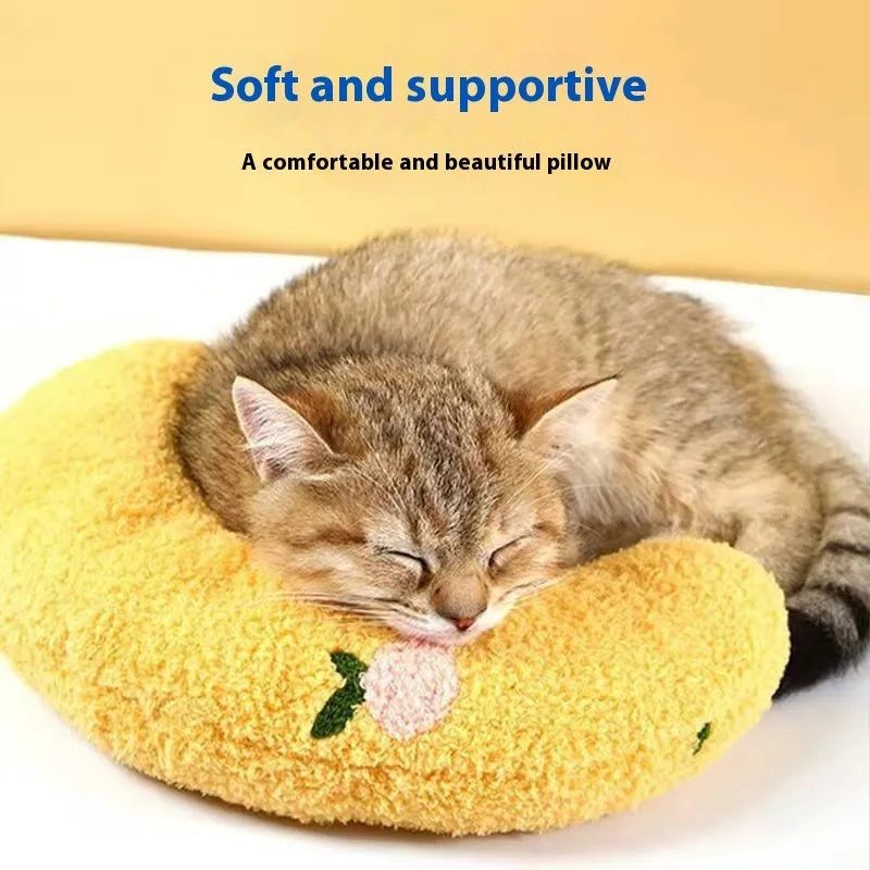 Blue U-shaped cat pillow with neck support in a question mark shape on a white background.