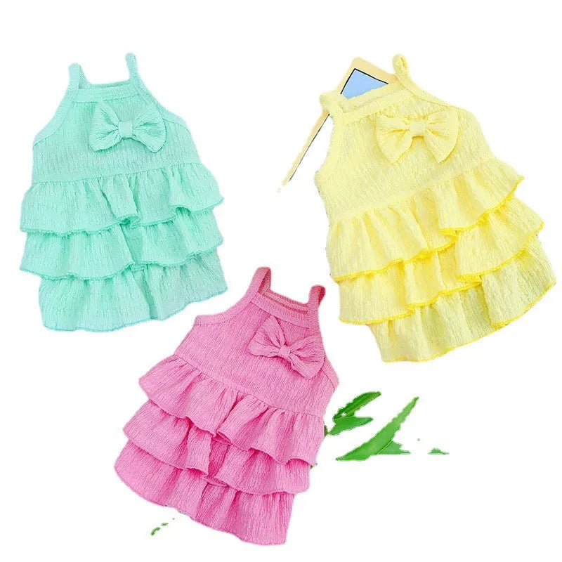 Small dog wearing princess dress with candy layered skirt in rose red colour