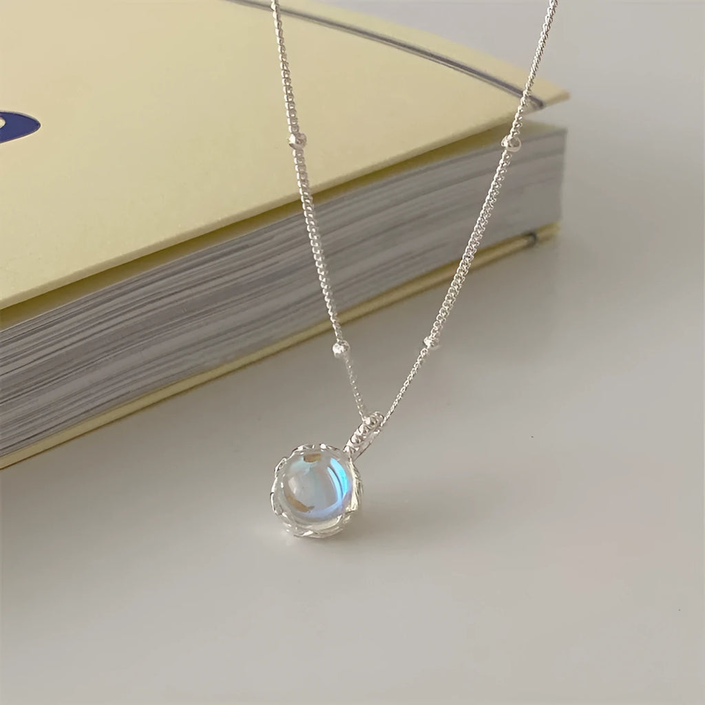 Women's sterling silver geometric stone pendant necklace on a curb chain, adjustable length.