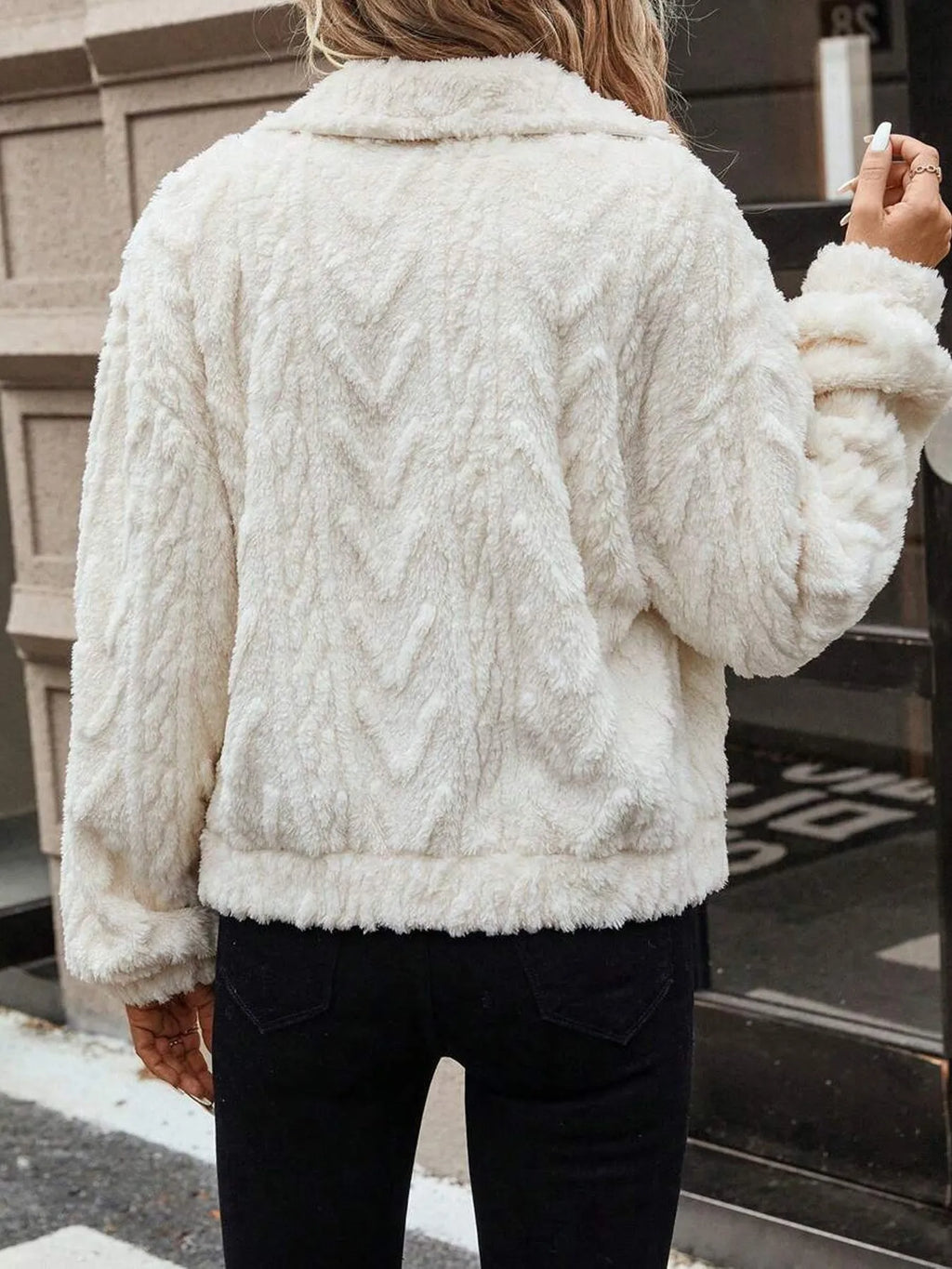 Ivory white women's double-sided plush button cardigan on a hanger.
