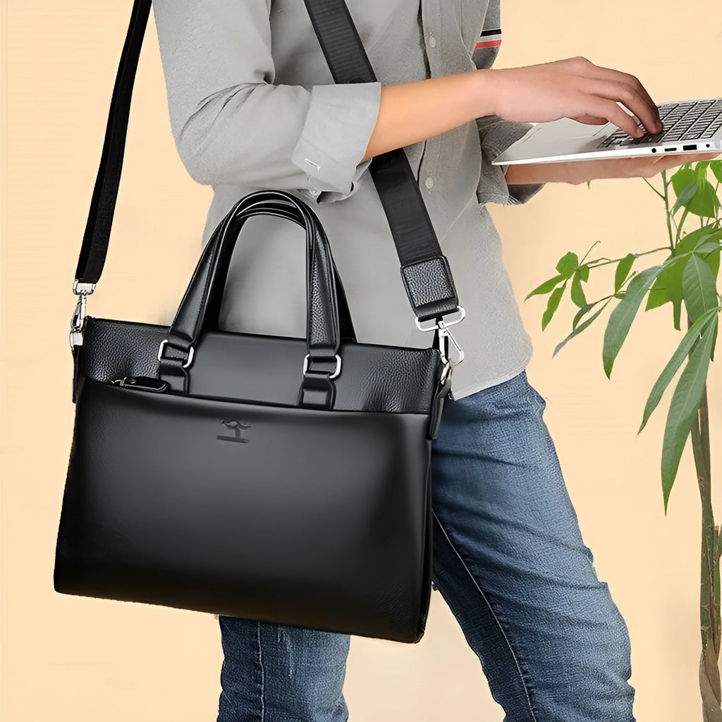 Men's black PU leather business messenger bag with spliced design shown from the side.