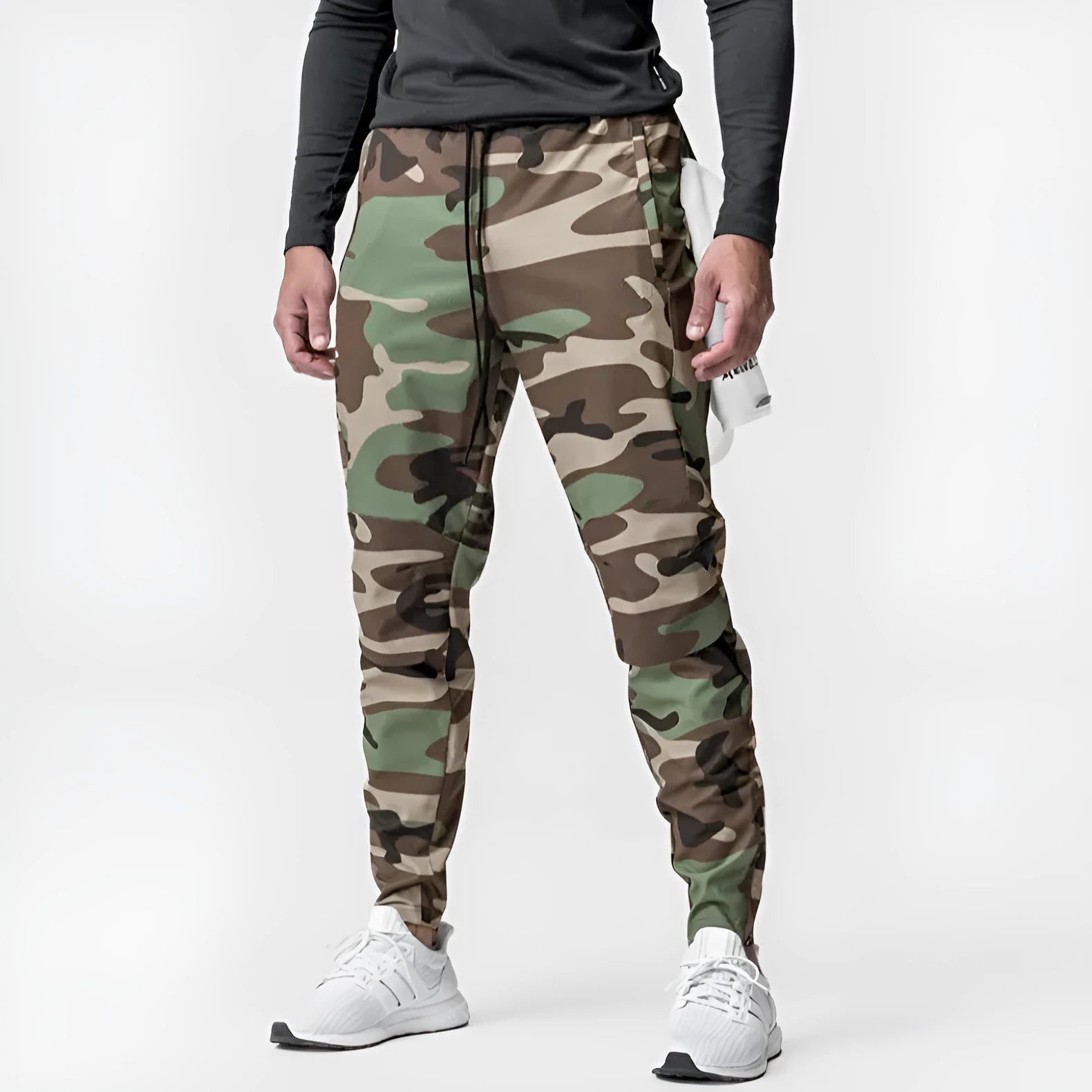 Man wearing loose grey ankle-tie fitness trousers suitable for running and gym workouts.