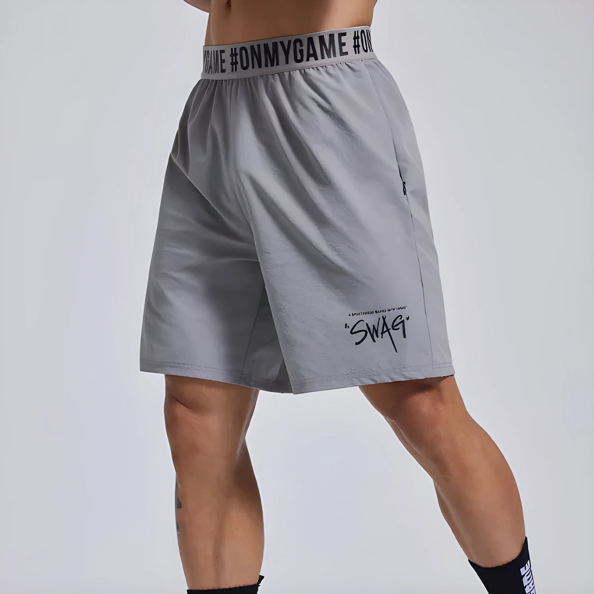 Men's black loose fit cropped workout shorts with elastic waistband and letter detailing