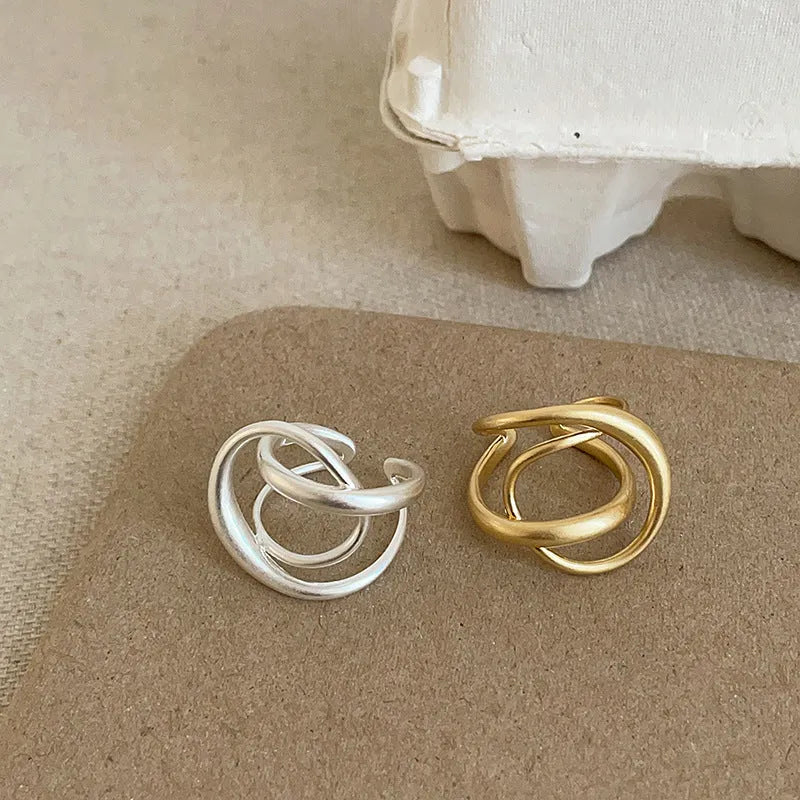 Geometric open ring with three-dimensional interlaced matte metal design and gold electroplating