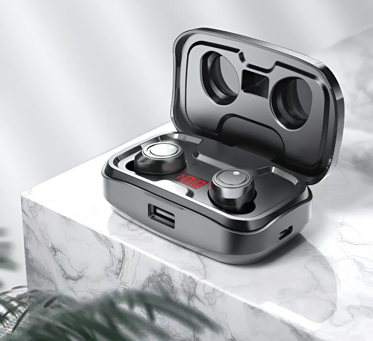 Black wireless Bluetooth earpieces with their plastic charging case on a table