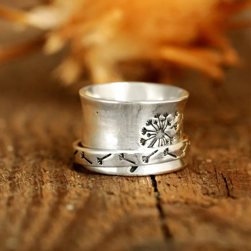 Silver rotatable flower ring showing spinning petals on alloy band