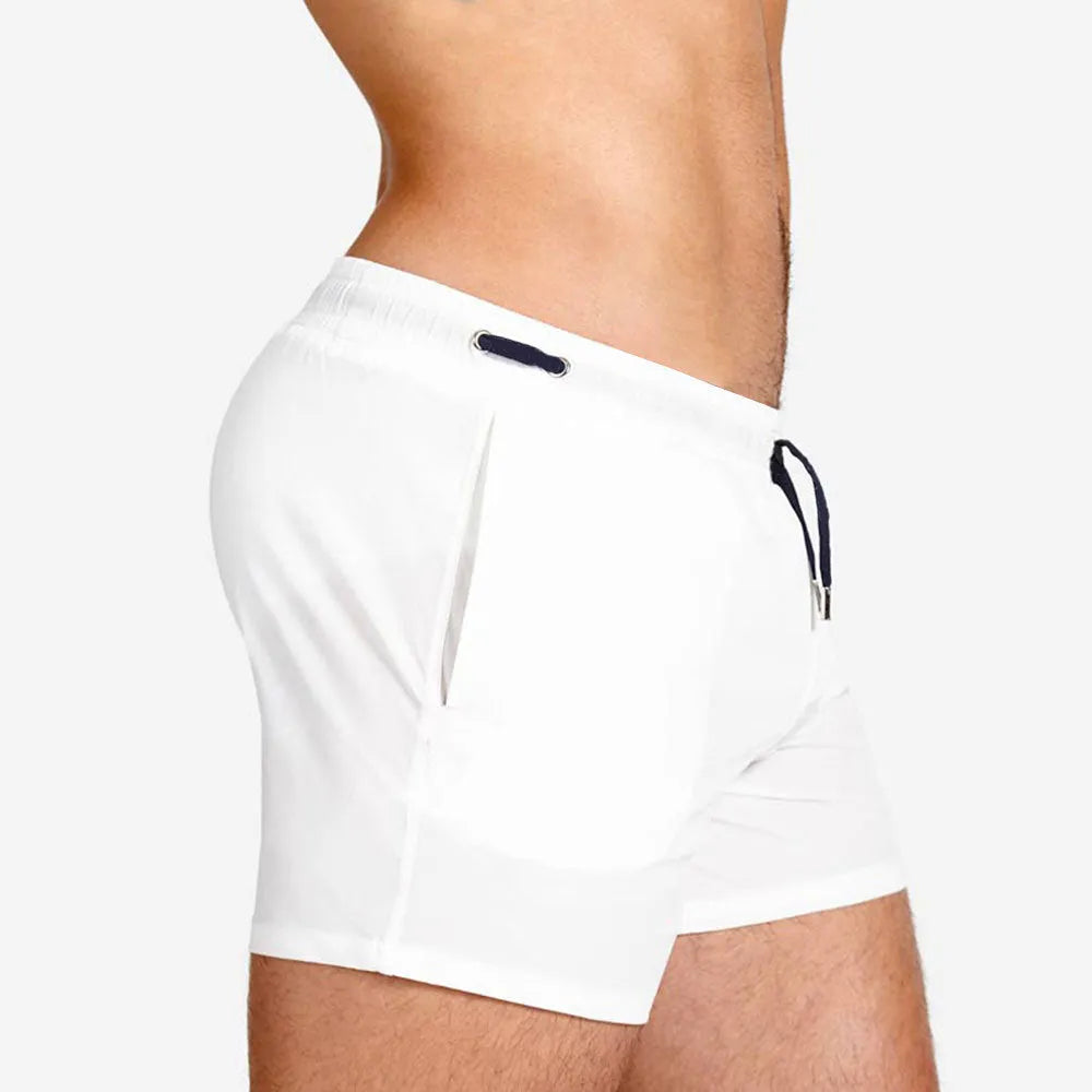 Men's solid colour polyester swimming shorts with mesh lining for sports and fitness.