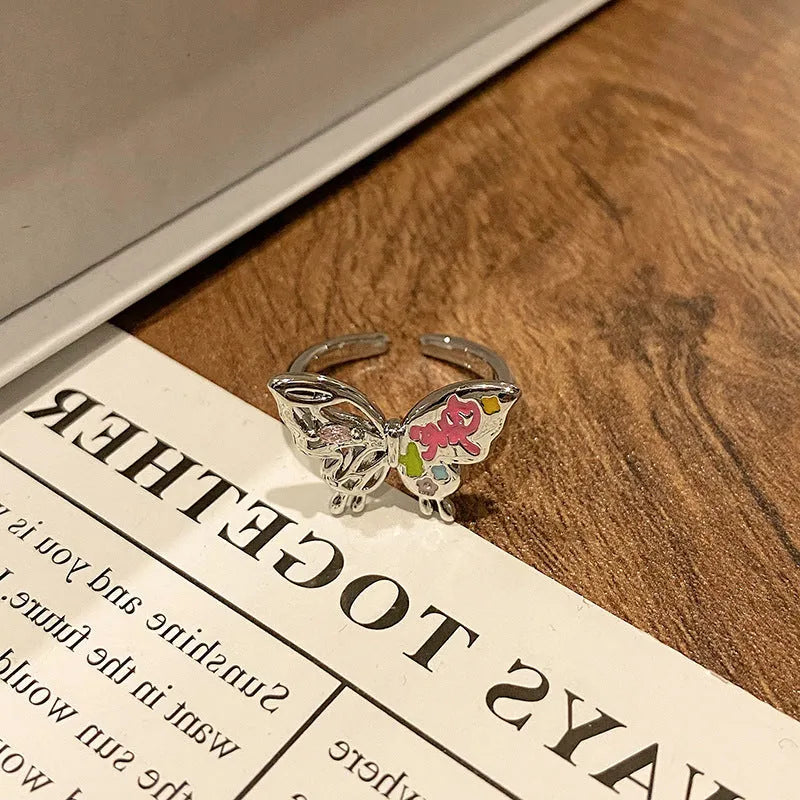 Copper butterfly women's ring with drip oil finish in an open-loop design.