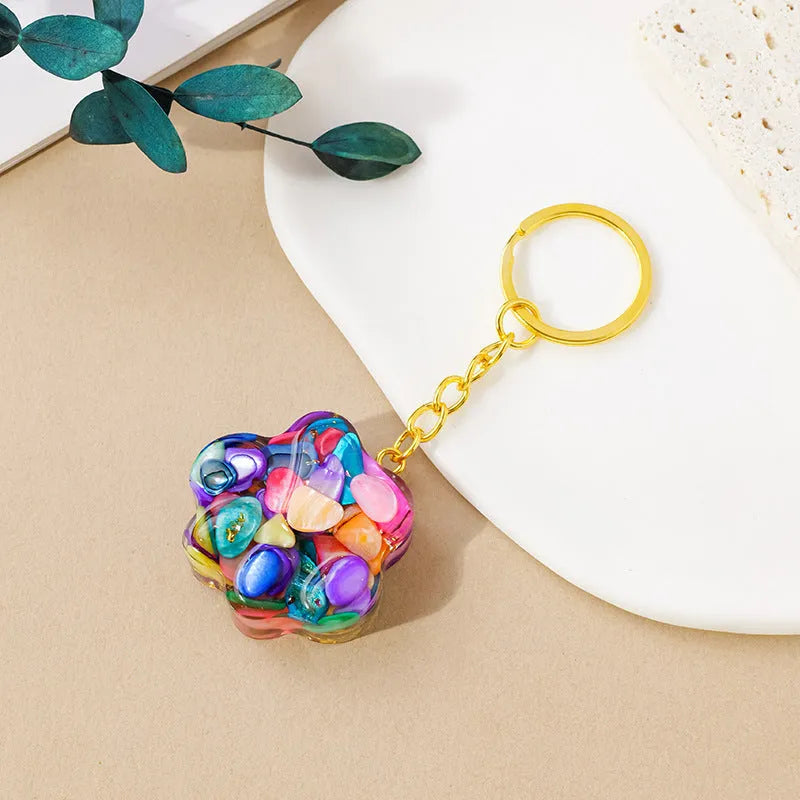 Small handcrafted crystal cat's paw shaped keychain pendant on a keyring.