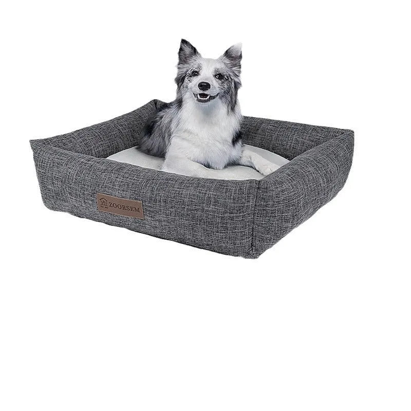 Square grey linen dog bed on a wooden floor for autumn and winter.