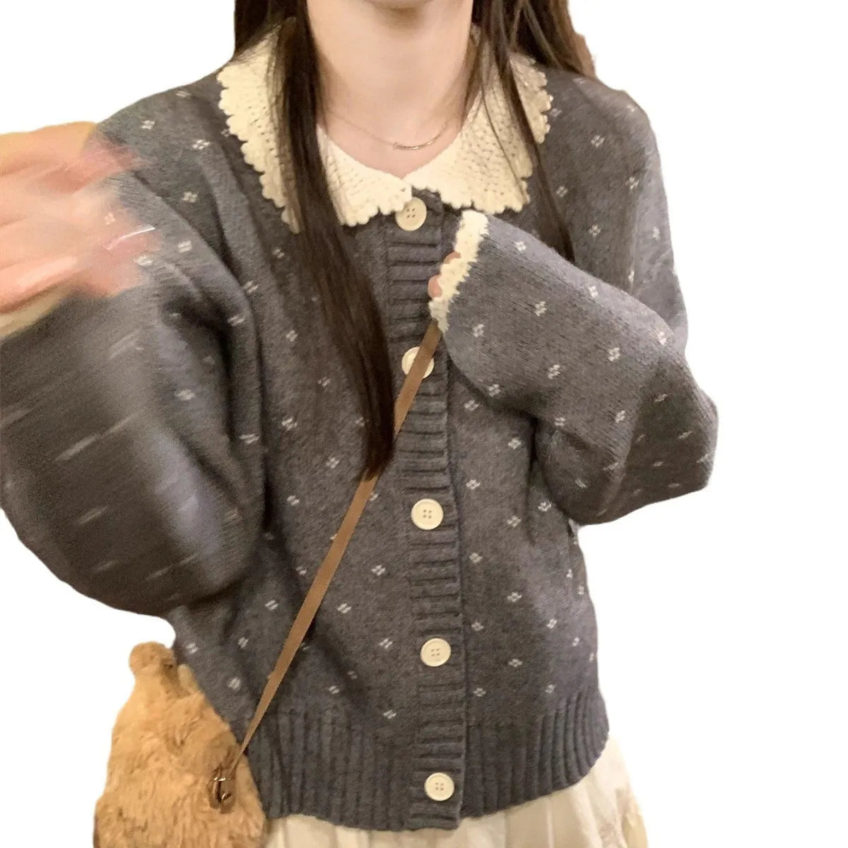 Navy blue floral patterned knitted cardigan coat with a white Peter Pan collar and button front.