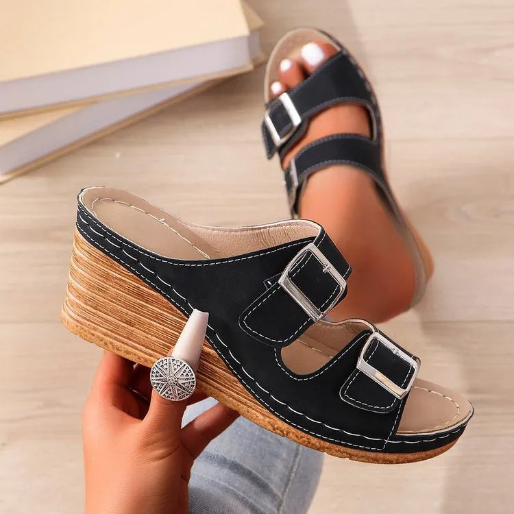 Women's creamy-white beach slippers with a wedge heel and an adjustable buckle strap across the foot.