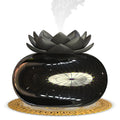 Pure black round USB aromatherapy humidifier on a surface