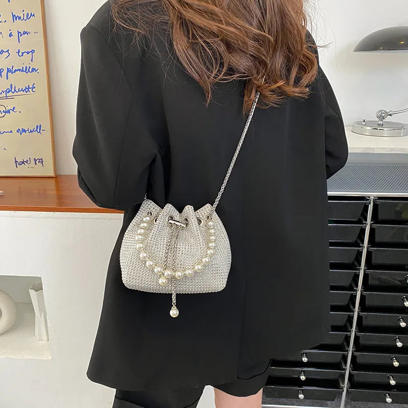 Women's fashion crossbody bag with diamond detailing and chain strap in soft PU material.