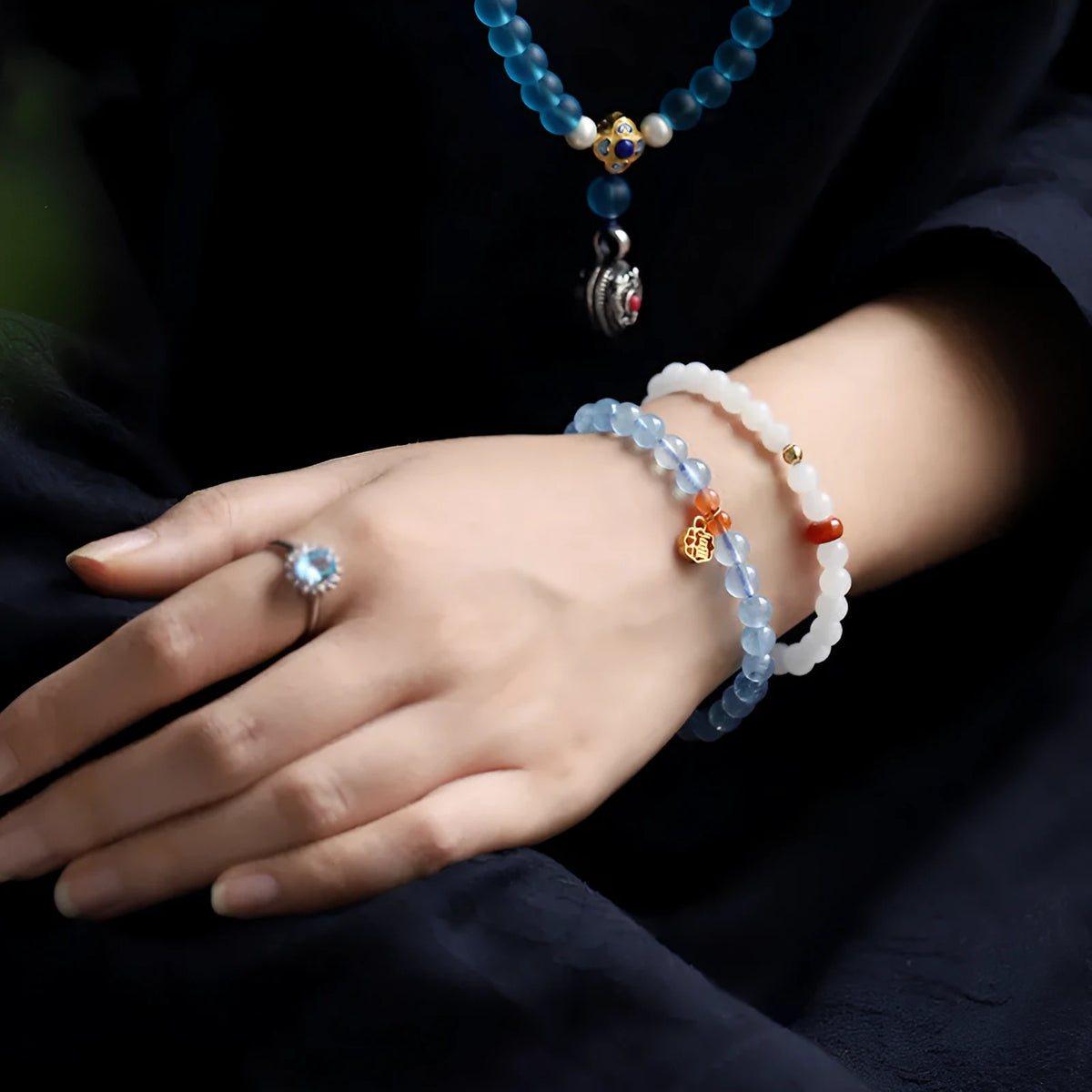 Women's crystal bracelet with ice translucent aquamarine 8mm round beads and sequin detailing on a white background.