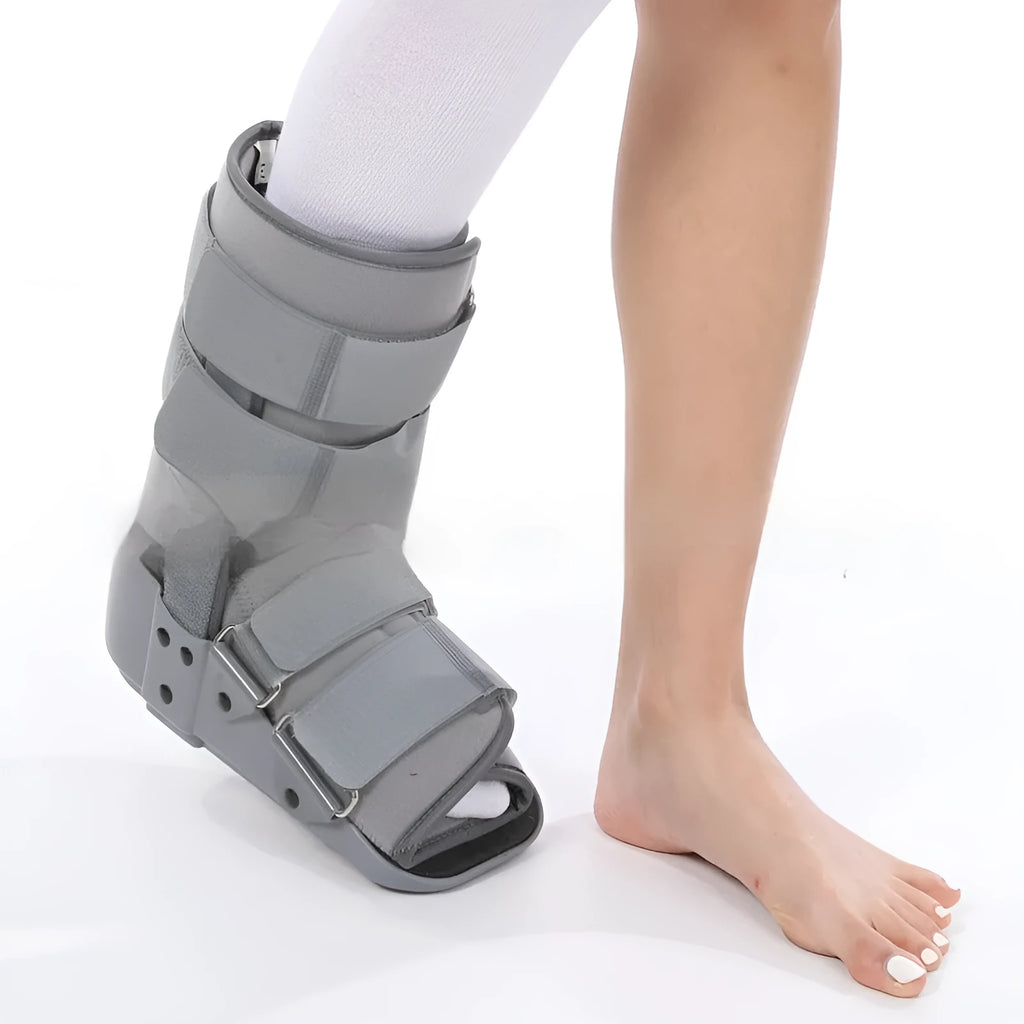 A black Achilles tendon rehabilitation boot with fixed support, showing straps and structural design.