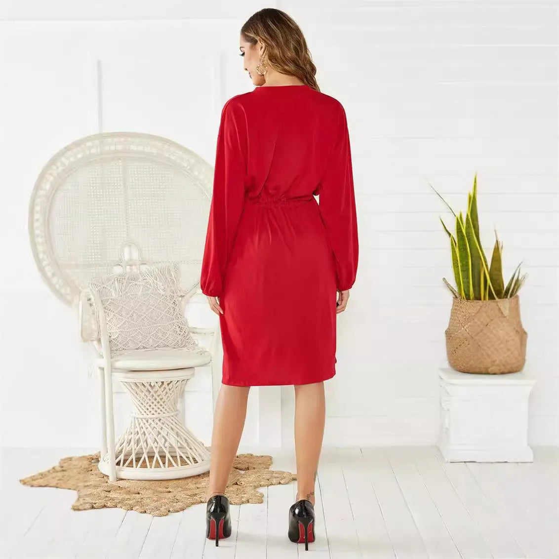 Black A-line midi dress with long sleeves, elastic waist, belt, and elastic cuffs on a mannequin.