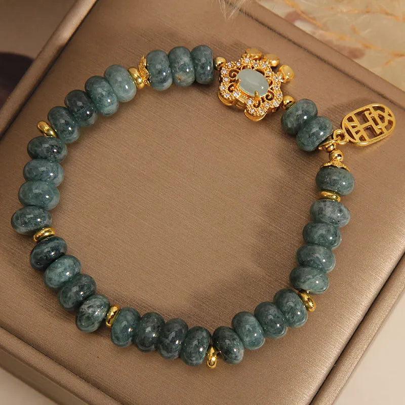 Natural emerald jade abacus bead bracelet for women with a metal safety lock closure.