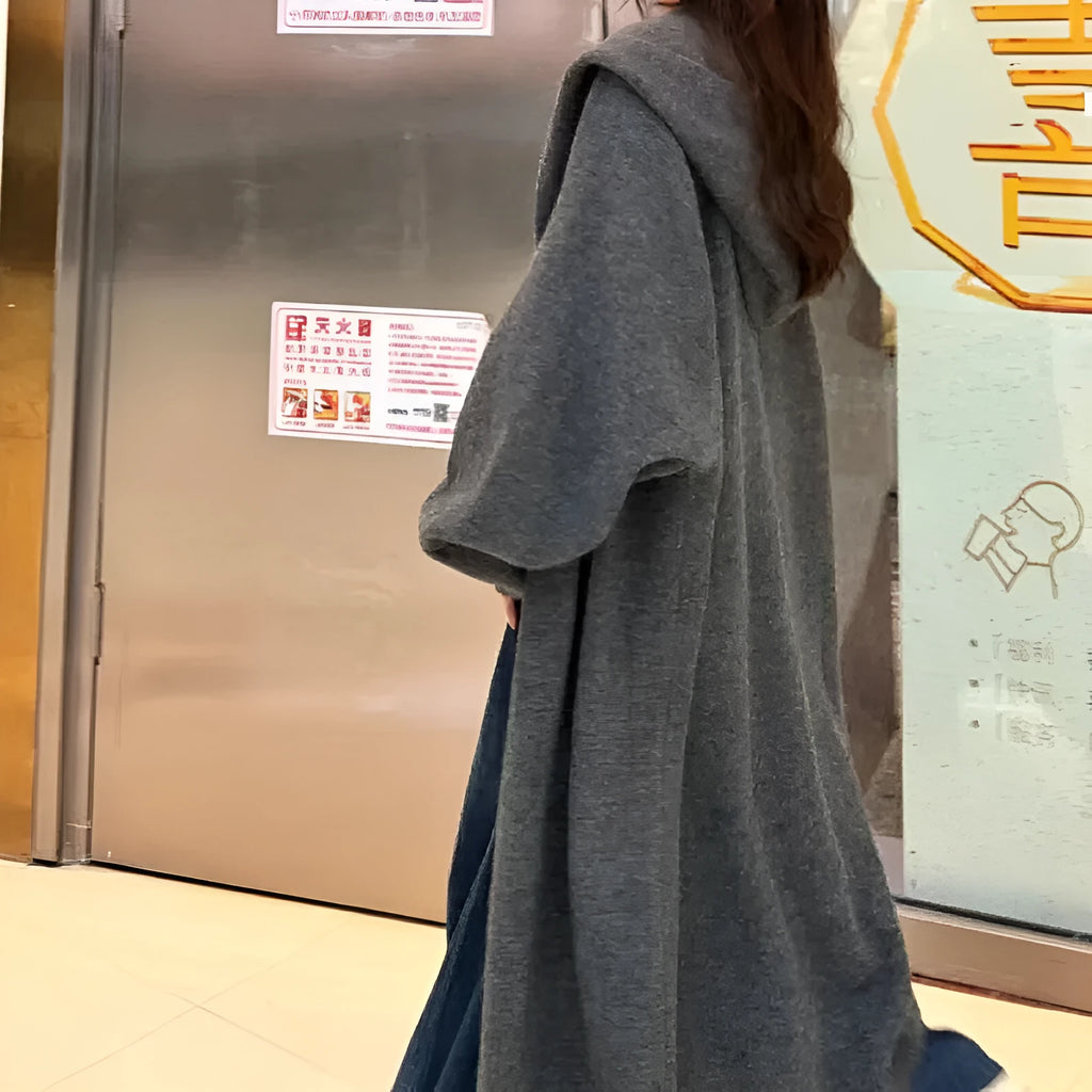 Women's long brown knitted hooded cardigan with a loose fit and below-the-knee length.