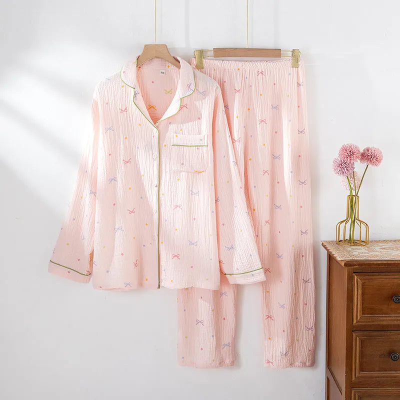 Women's lightweight pink cotton pyjama set with long sleeves and full-length trousers.