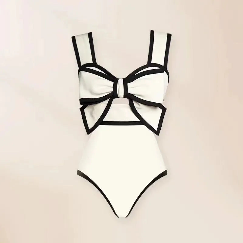 Women's black one-piece swimsuit with white bow and skirt for swimming
